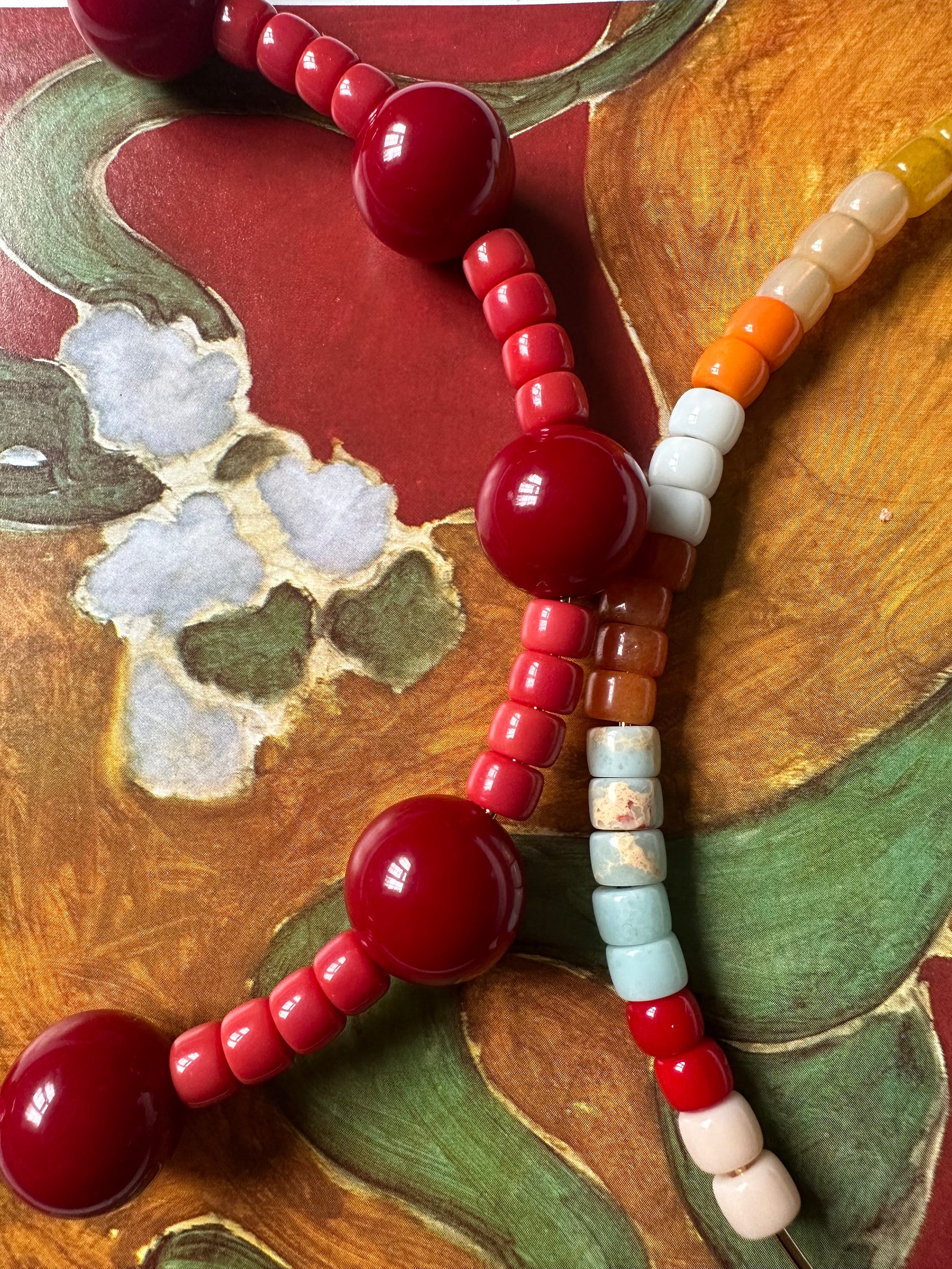 Colorful beaded necklace on a decorative wooden surface